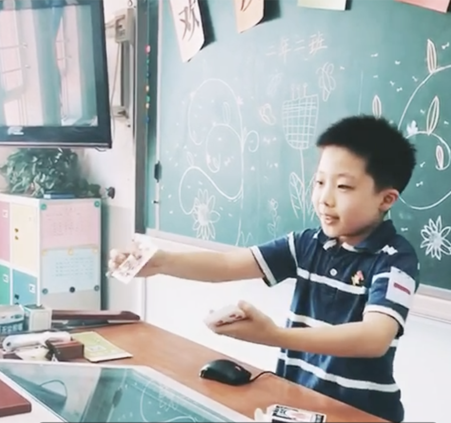 Brian Zhang performing card magic in his classroom as a child